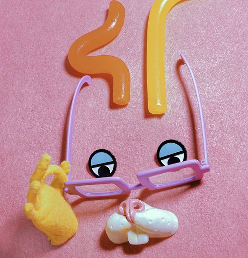 "Collection of playful props including eyes, glasses, teeth and a glove
