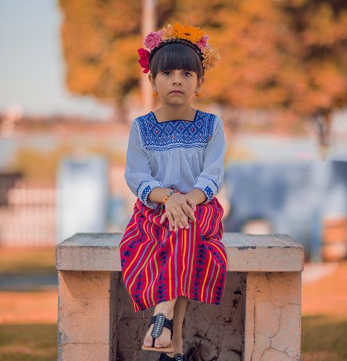 Little girl sitting with a flower crown