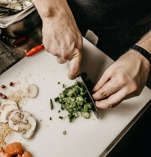Hands chopping fresh herbs